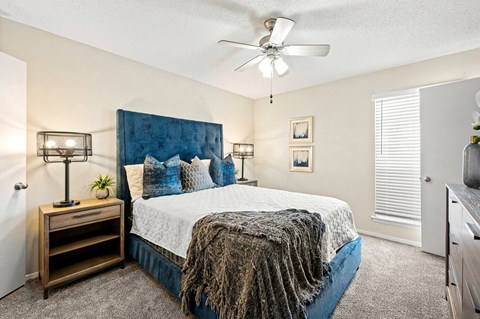 a bedroom with a bed and a ceiling fan at Keller Oaks, Carrollton 