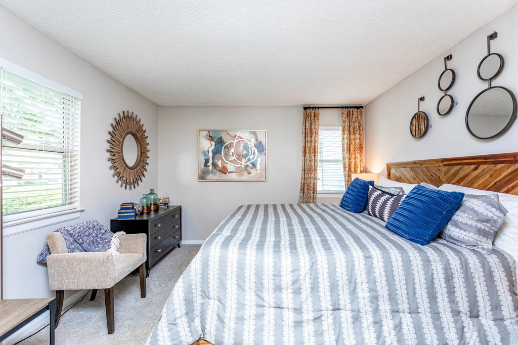 a bedroom with a bed and a dresser and a window