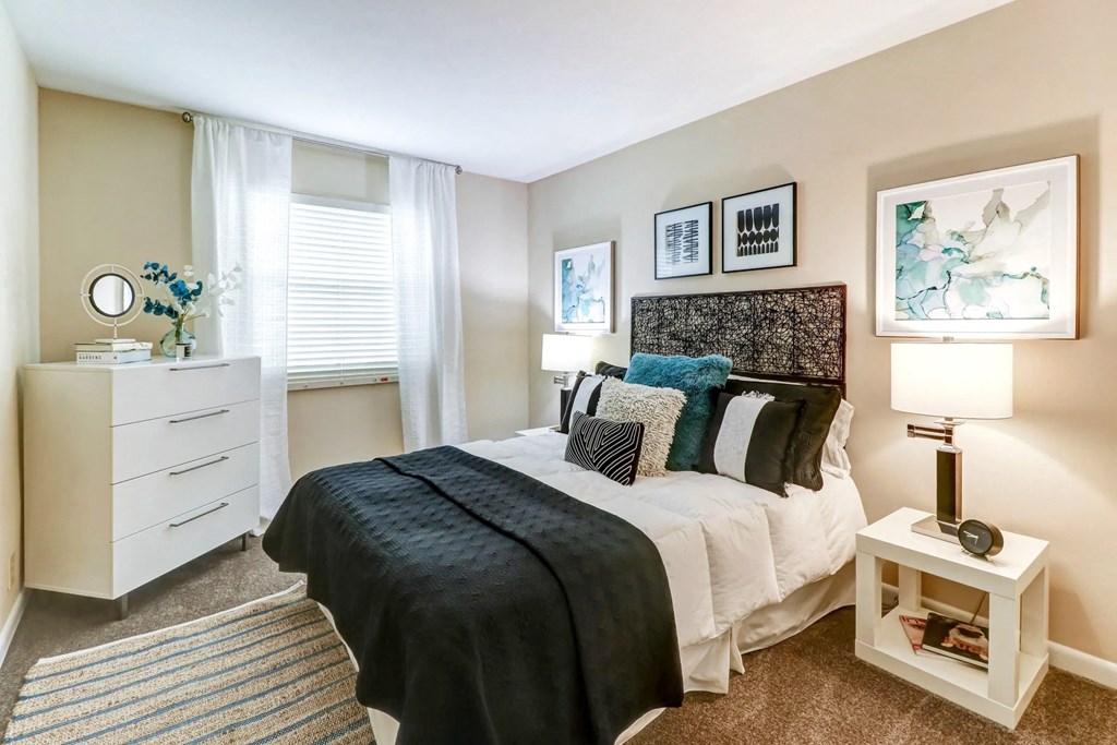 a bedroom with a bed and a dresser