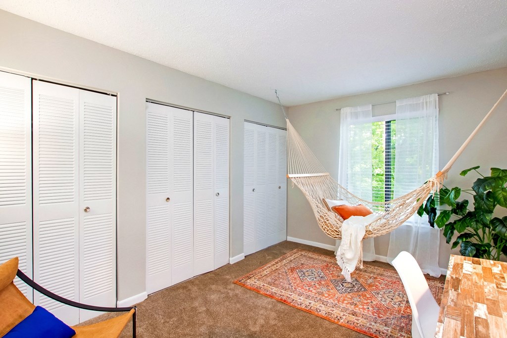a hammock in the corner of a room with closet doors