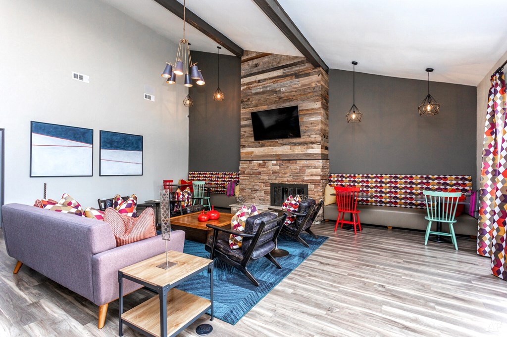 a living room with a couch and chairs and a fireplace