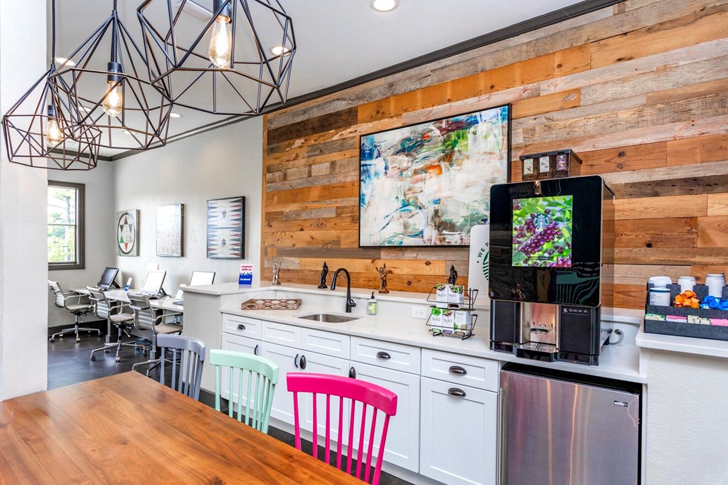 the kitchen and dining area of a home with a wood accent wall