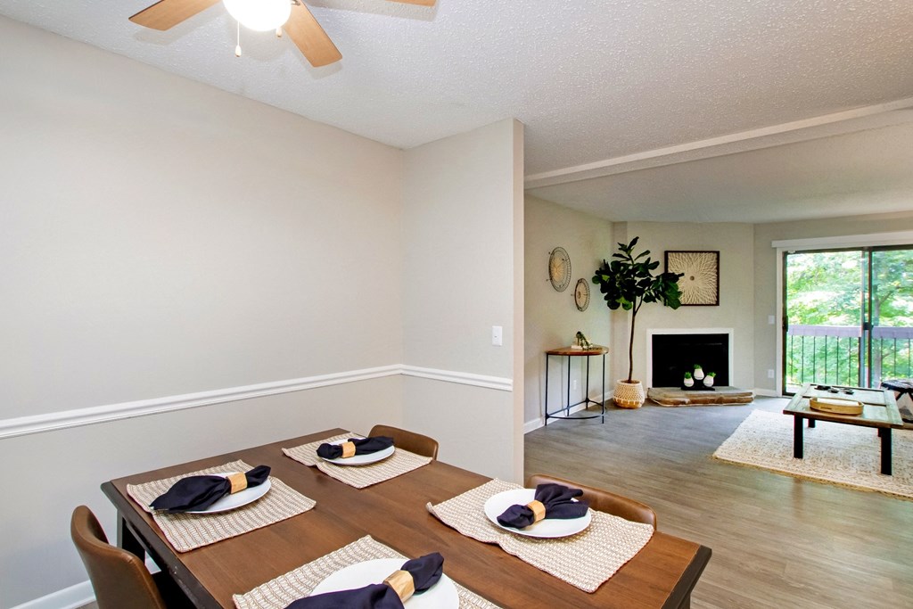 an open living room and dining room with a table and chairs