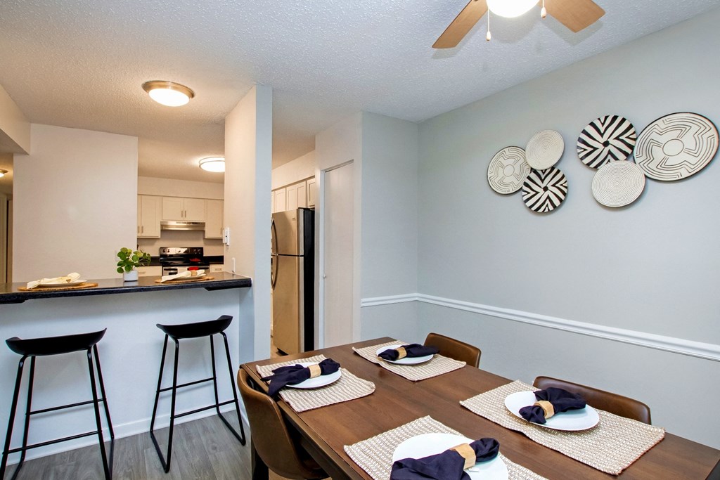 an open kitchen and dining room with a dining table and stools