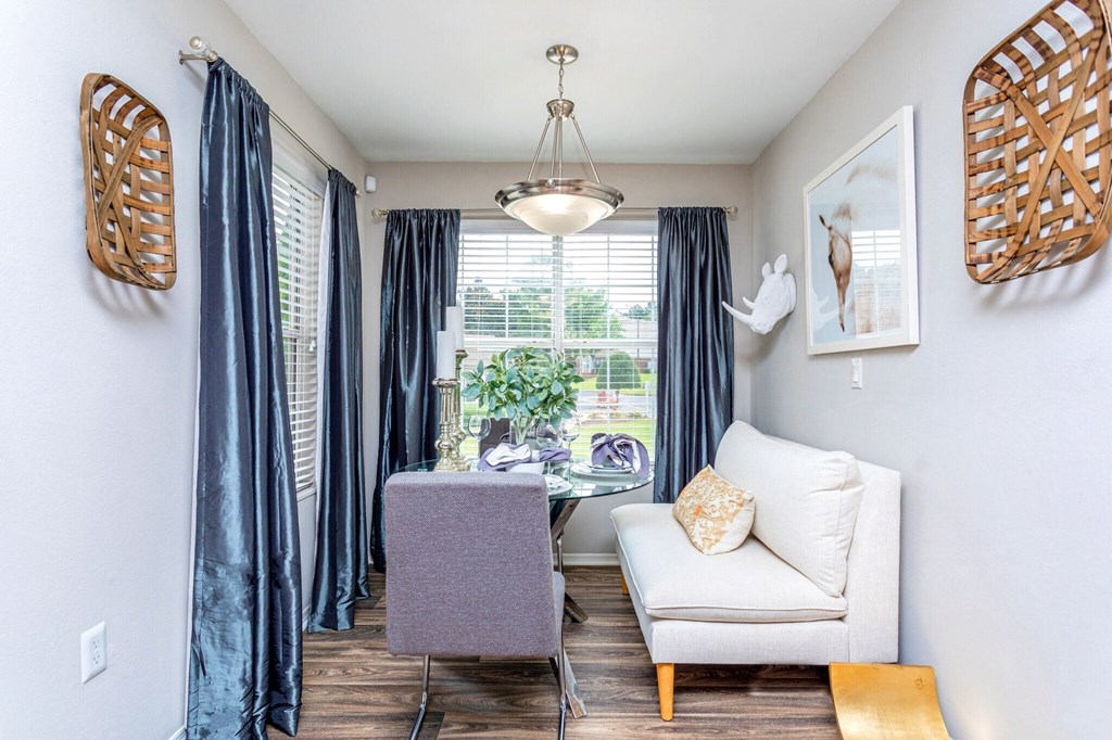 a living room with a chair and a table and a window