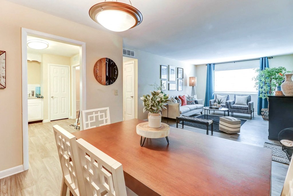 a dining room and living room with a table and a living room