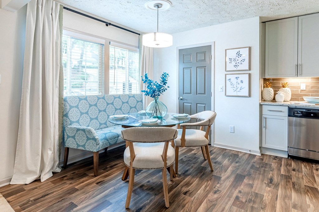 a dining room with a table and chairs and a kitchen