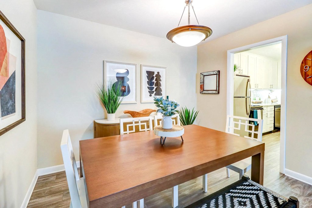 a dining room area with a wooden table and chairs