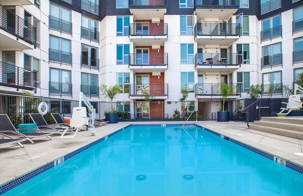 the pool of an apartment building with a blue pool