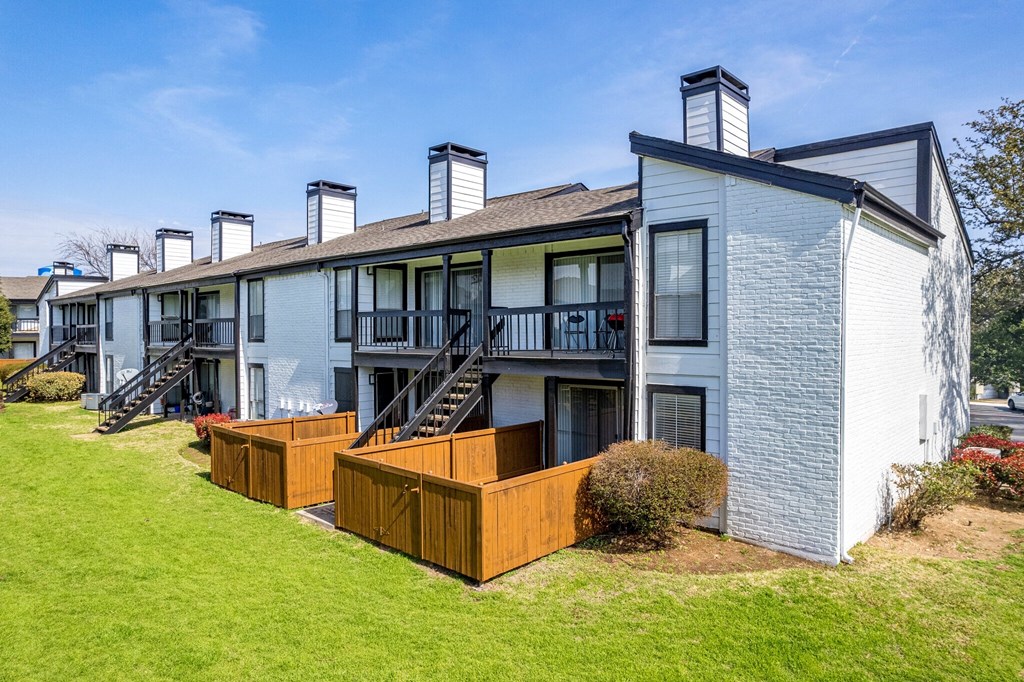 a row of apartment buildings with wooden decking at Keller Oaks, Carrollton, TX 75006 ?