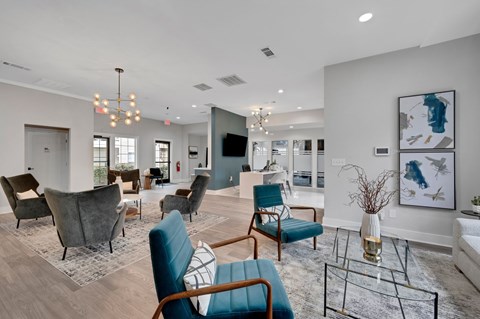 A living room with a blue chair in the foreground.