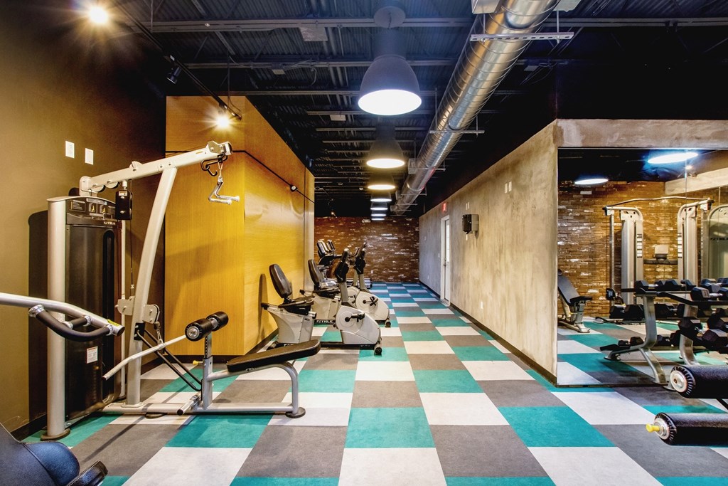 a workout room with weights and a checkered floor