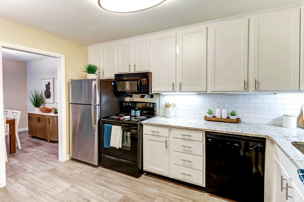 a kitchen with stainless steel appliances and white cabinets