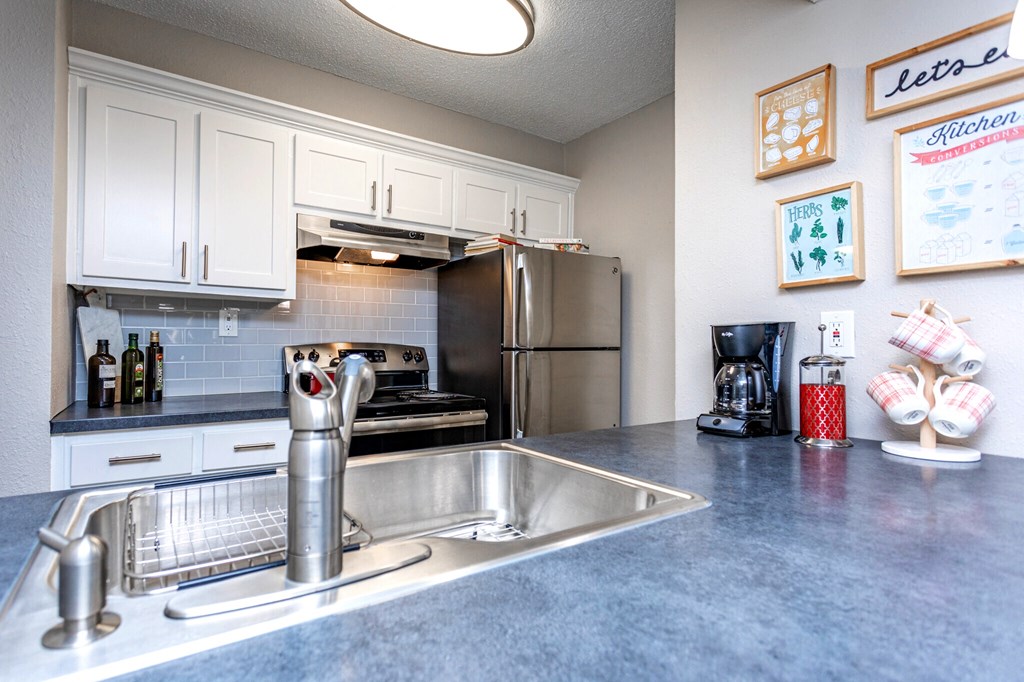 a kitchen with stainless steel appliances and a sink
