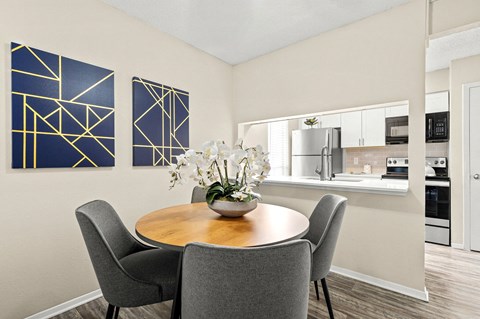 a dining room with a table and chairs and a kitchen