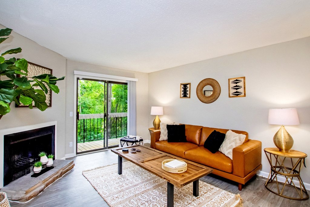 a living room with a couch and a coffee table and a fireplace
