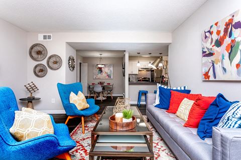 a living room with blue chairs and a couch