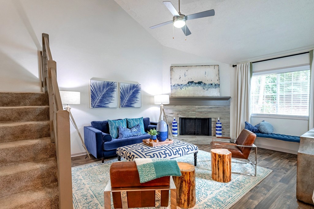 a living room with a blue couch and a fireplace
