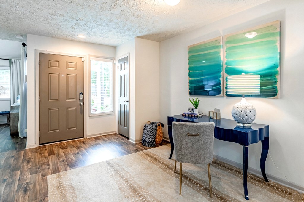 a home office with a desk and chair and a door