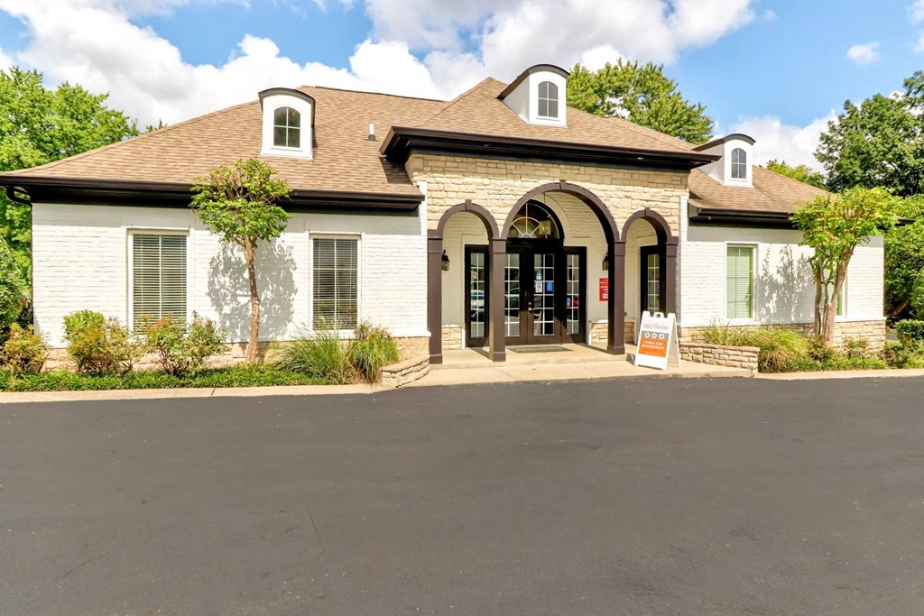 the front door of a building with a sign in front of it