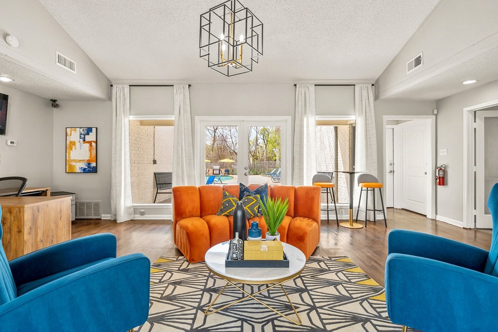 a living room with blue and orange furniture and a table at The Hudson, Carrollton, 75006 ?