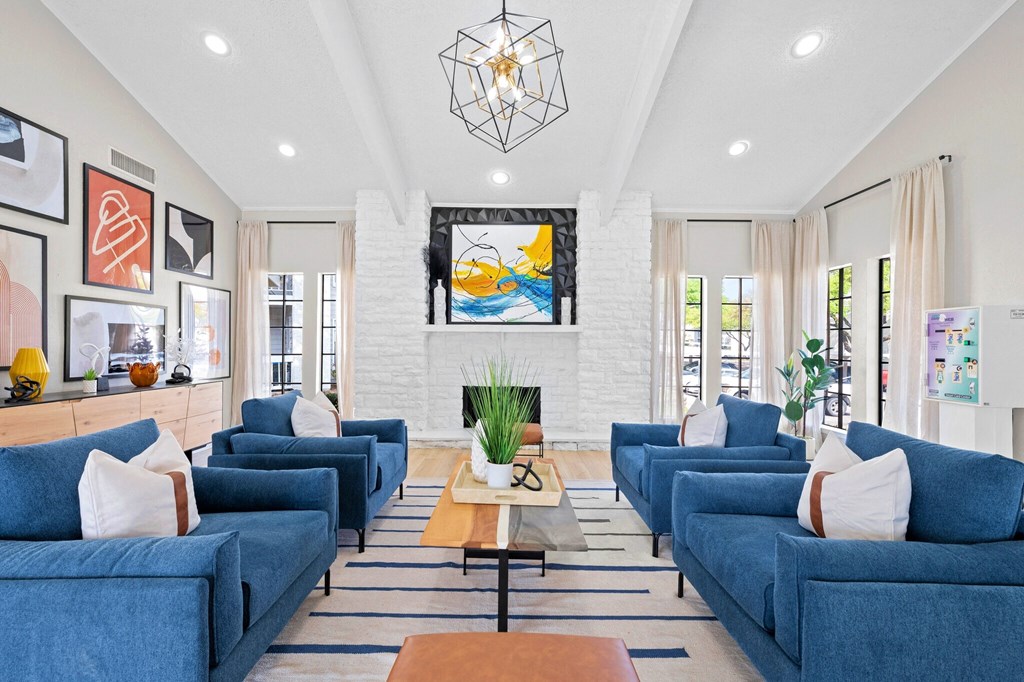 a living room with blue couches and a fireplace