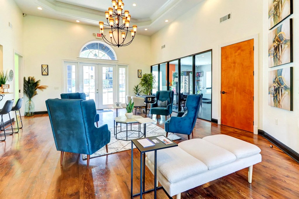 a living room with blue chairs and a white couch
