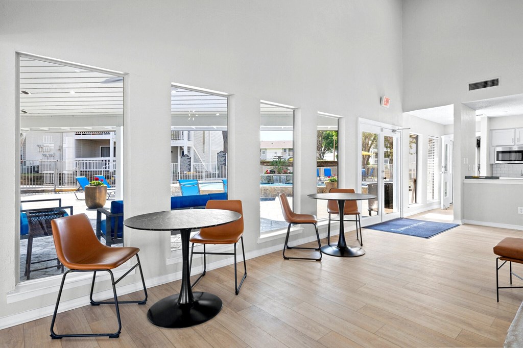 a communal area with tables and chairs in a building