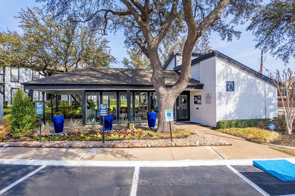 the front of a building with a tree and a parking lot at Keller Oaks, Carrollton, TX ?