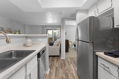 a kitchen with a sink and a refrigerator
