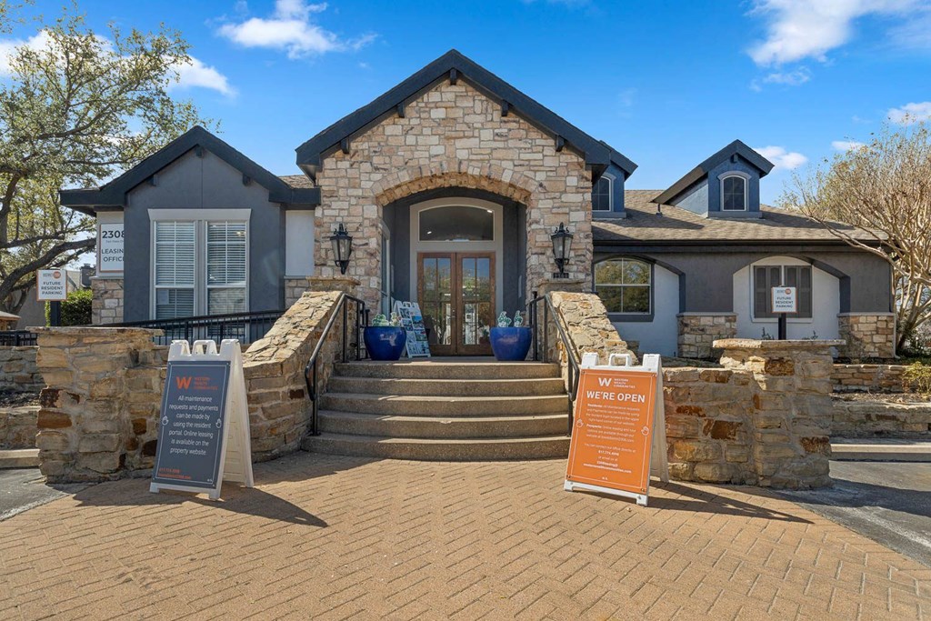 the front of a house with steps and a sign in front at District 2308, Texas 