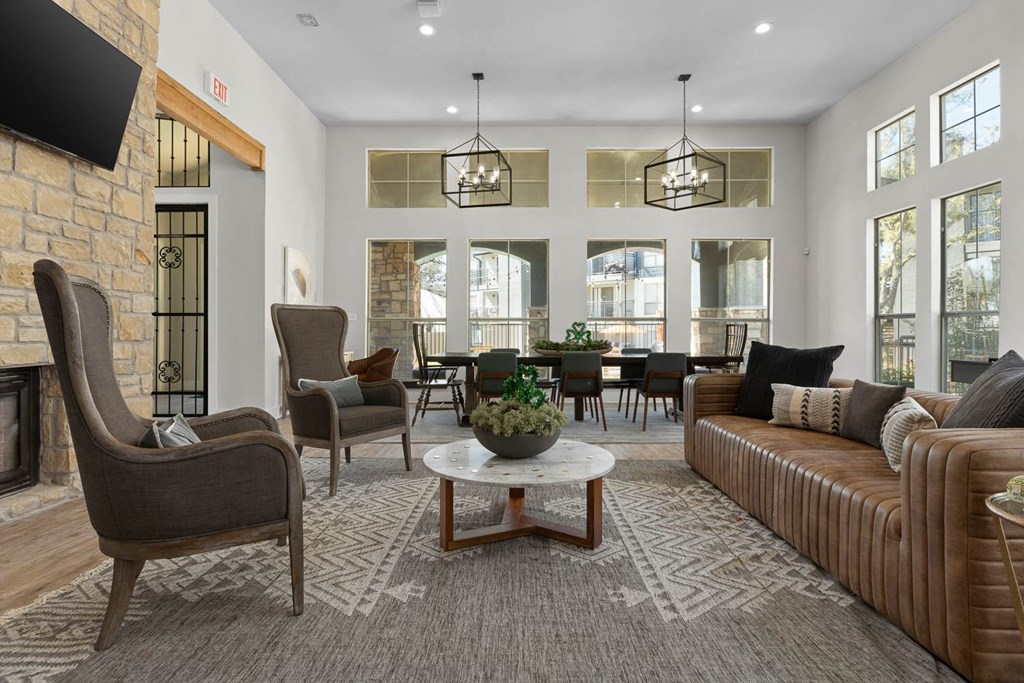 a living room with couches and chairs and a table at District 2308, Arlington Texas?