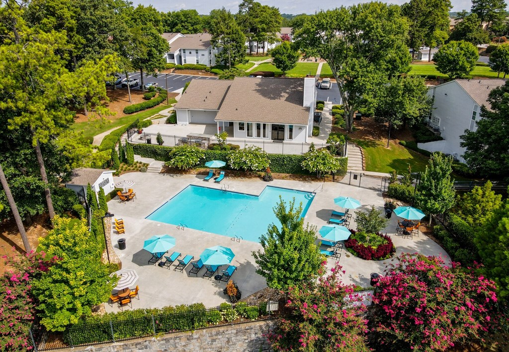 a aerial view of a swimming pool with umbrellas