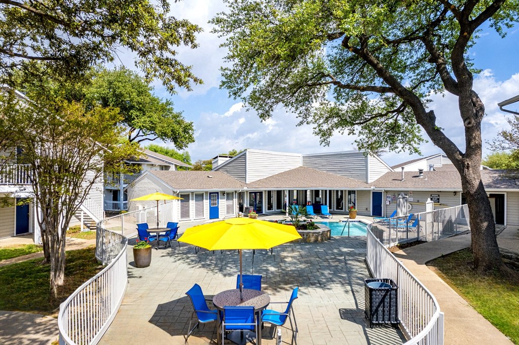 our apartments have a large patio with chairs and umbrellas