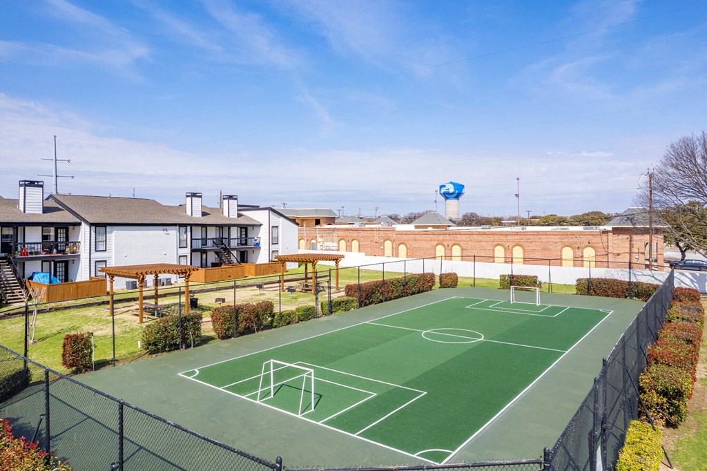 an outdoor basketball court with houses in the background an outdoor basketball court with houses in the background at Keller Oaks, Carrollton, TX 75006 ?