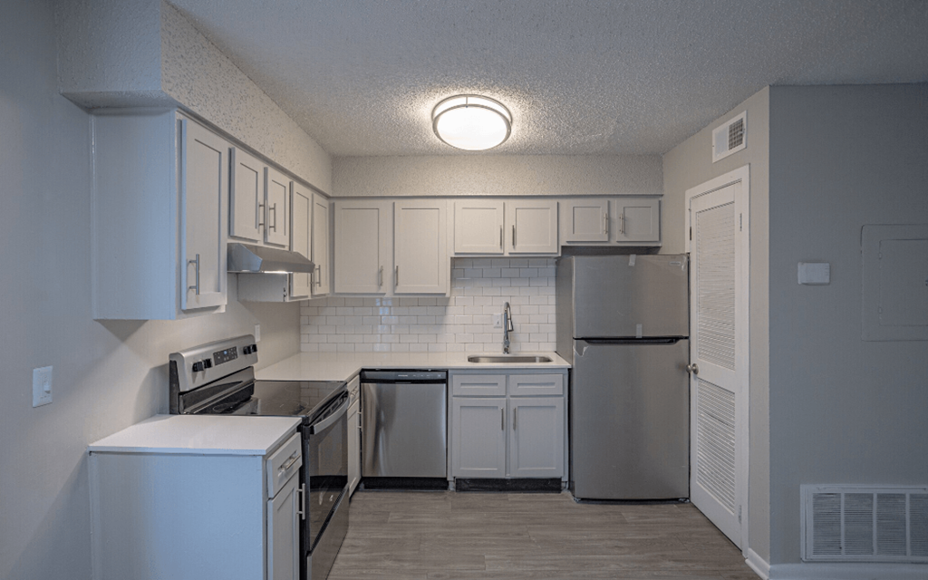 Kitchen with white cabinets and stainless steel appliances at Willow Apartments, Nashville, Tennessee