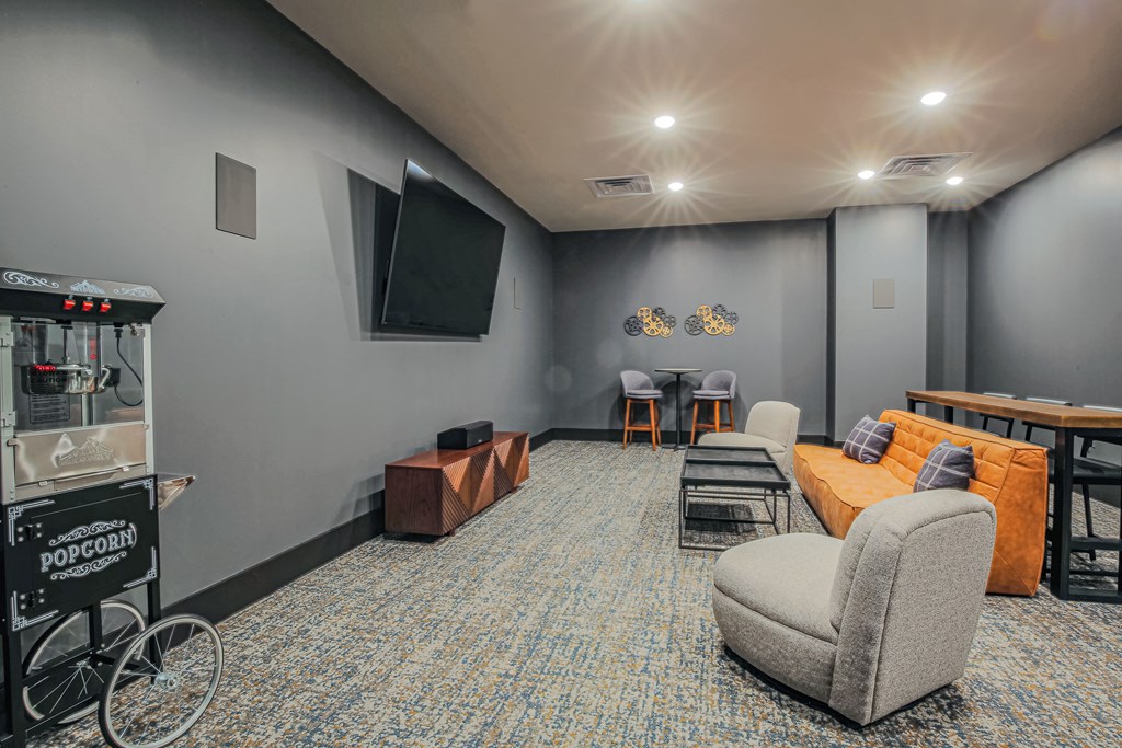 a living room with a couch and chairs and a television