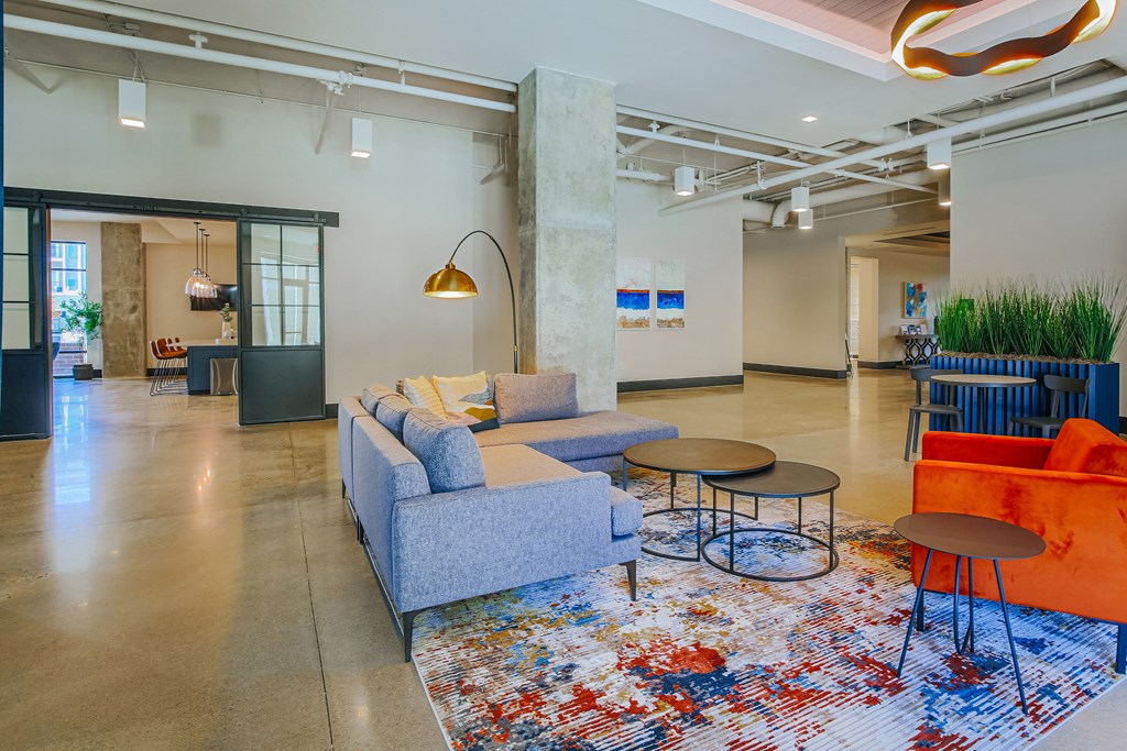 a living room with couches and tables on a rug