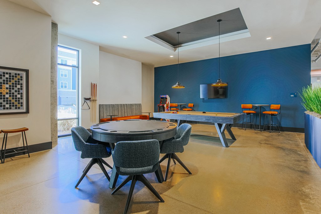 a game room with a ping pong table and a blue wall