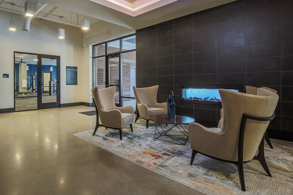 a living room with chairs and a fire place