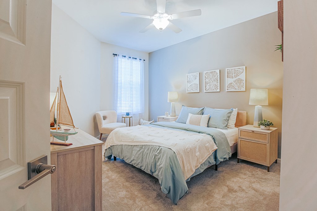 a bedroom with a large bed and a ceiling fan