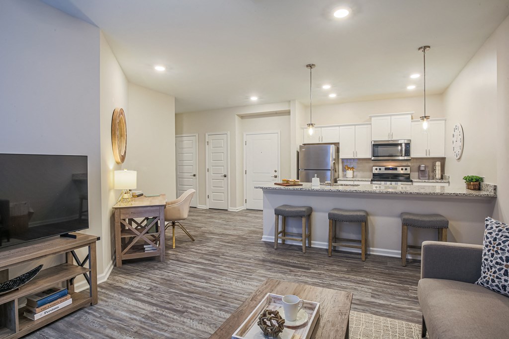 a living room with a kitchen and a television