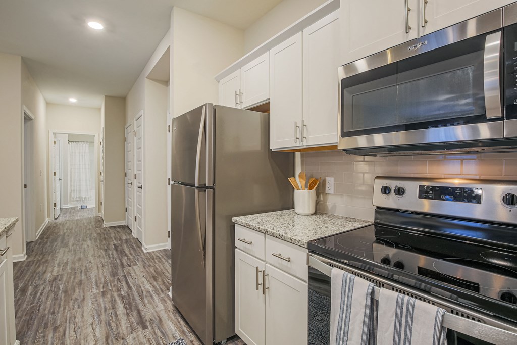 a kitchen with stainless steel appliances and white cabinets