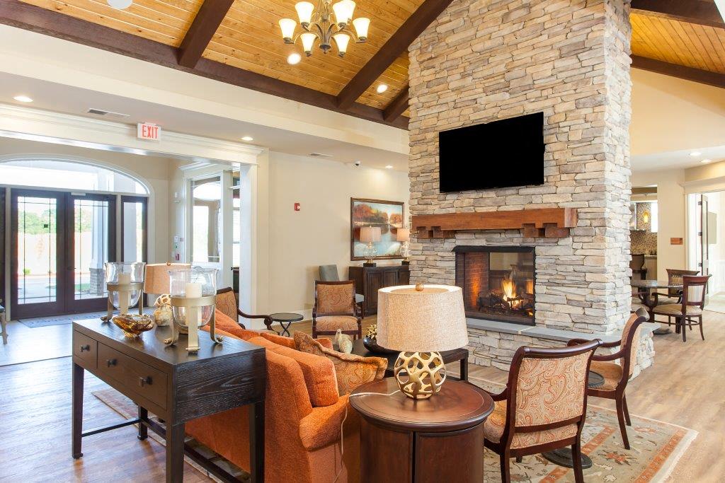 a large living room with a stone fireplace and furniture