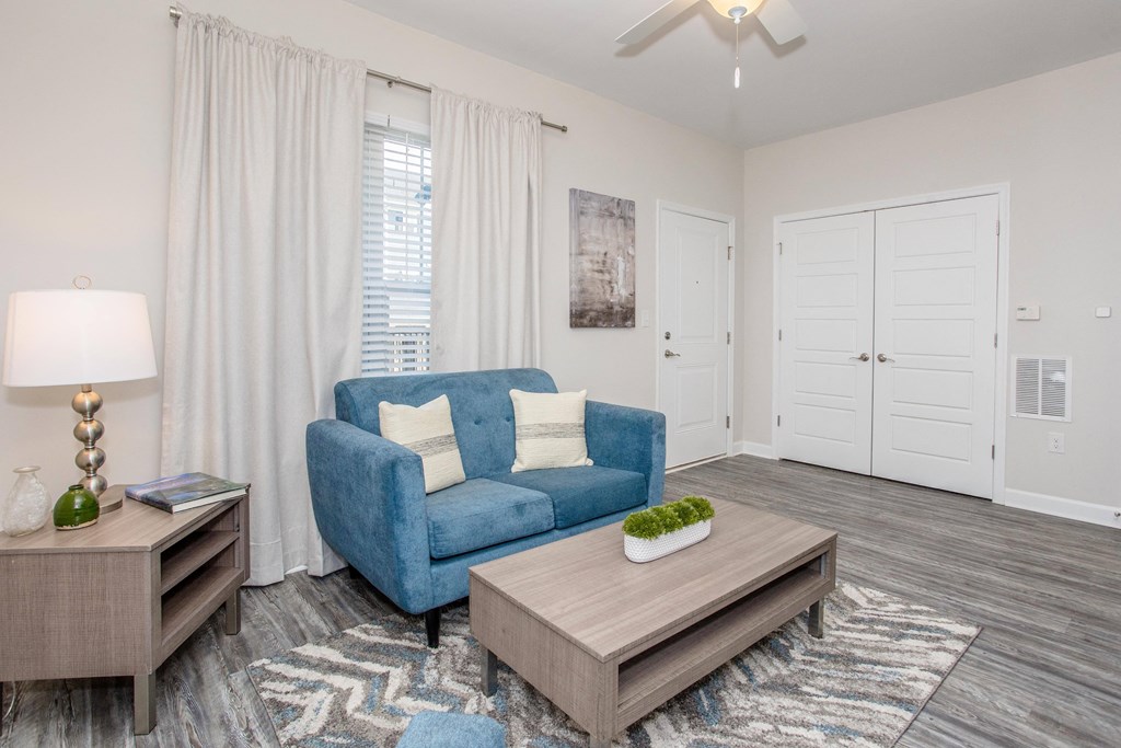 a living room with a blue couch and a coffee table