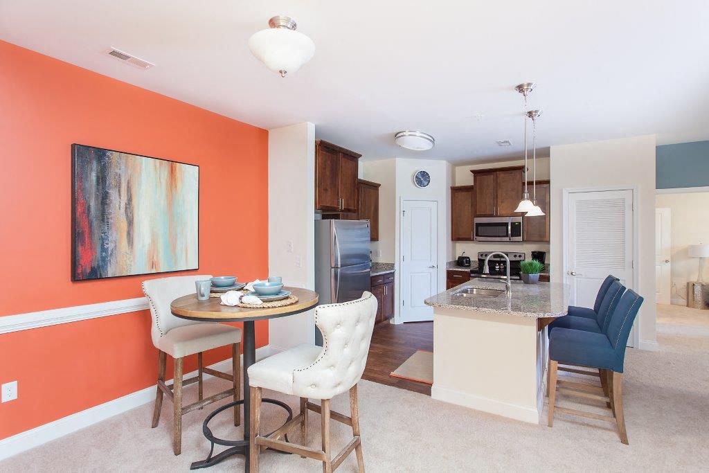 a kitchen and dining room with a table and chairs