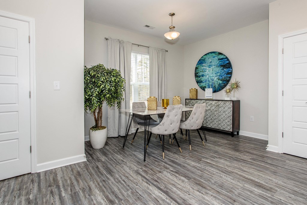 a dining room with white walls and a table and chairs