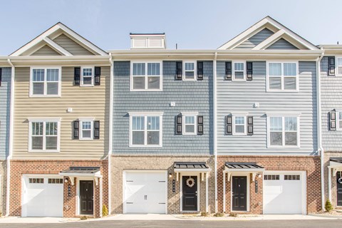 a row of three story houses with white doors