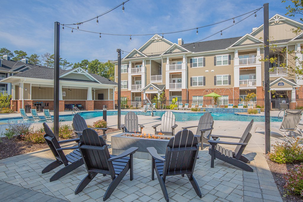 our apartments feature a swimming pool and patio with chairs