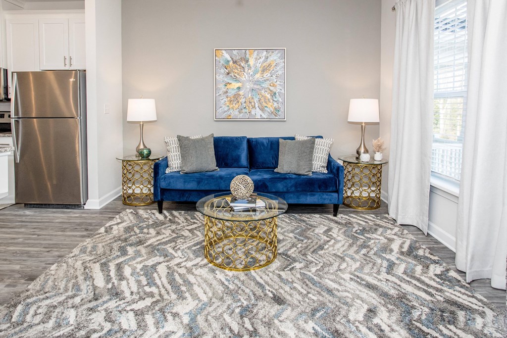 a living room with a blue couch and a rug